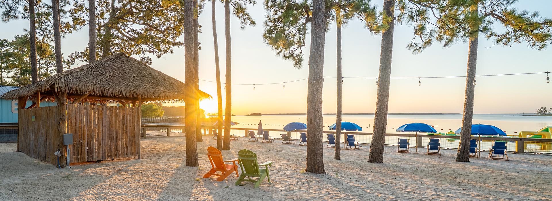 the-district-on-255-waterfront on lake rayburn chairs and umbrellas sitting beside lake  sam rayburn